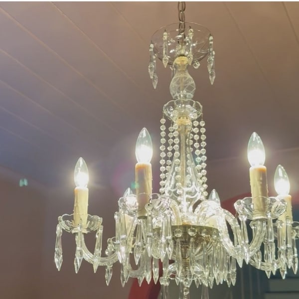 A crystal chandelier found in an upstairs closet, restored and lit.